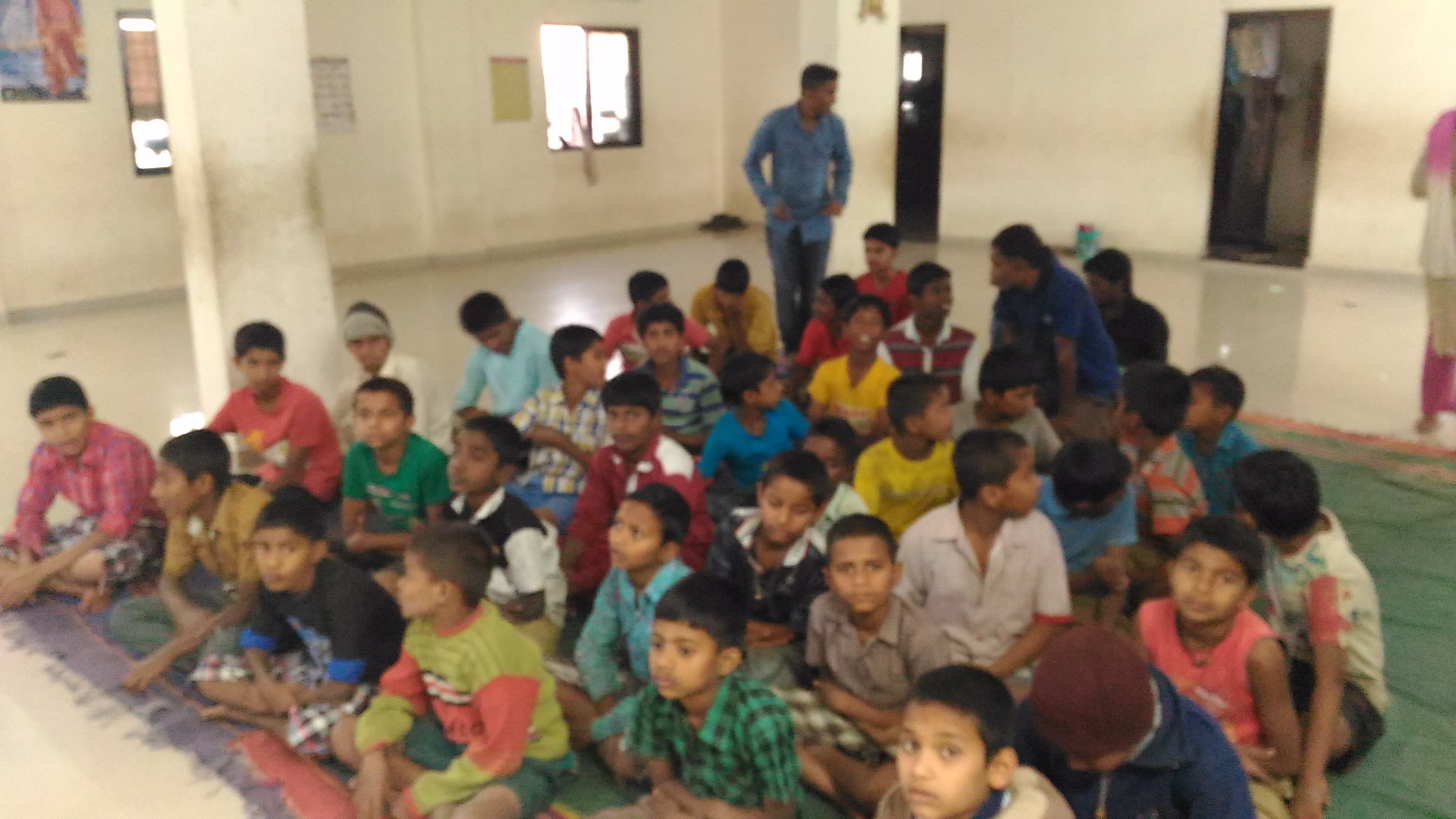 Students at Vadgaon Anathashram receiving quantum physics books